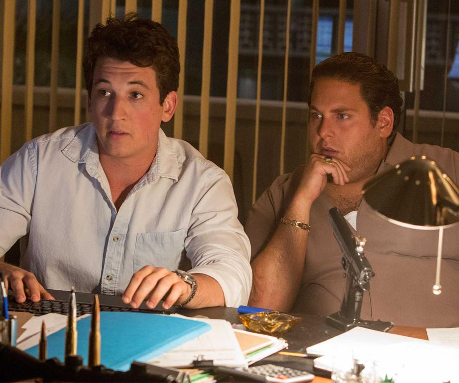 Still from War Dogs (2016), night office at screens; reference for always-on tender monitoring, not an endorsement